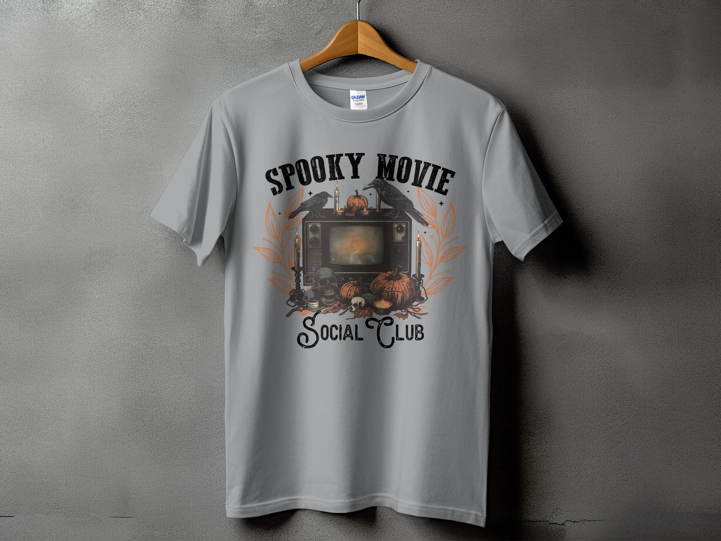 T-shirt with "Spooky Movie Social Club" text and Halloween-themed illustration.