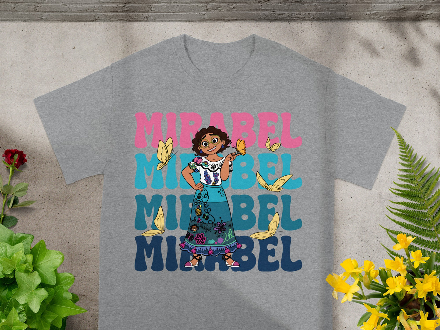 Mirabel Madrigal from Encanto with butterflies on a grey t-shirt.