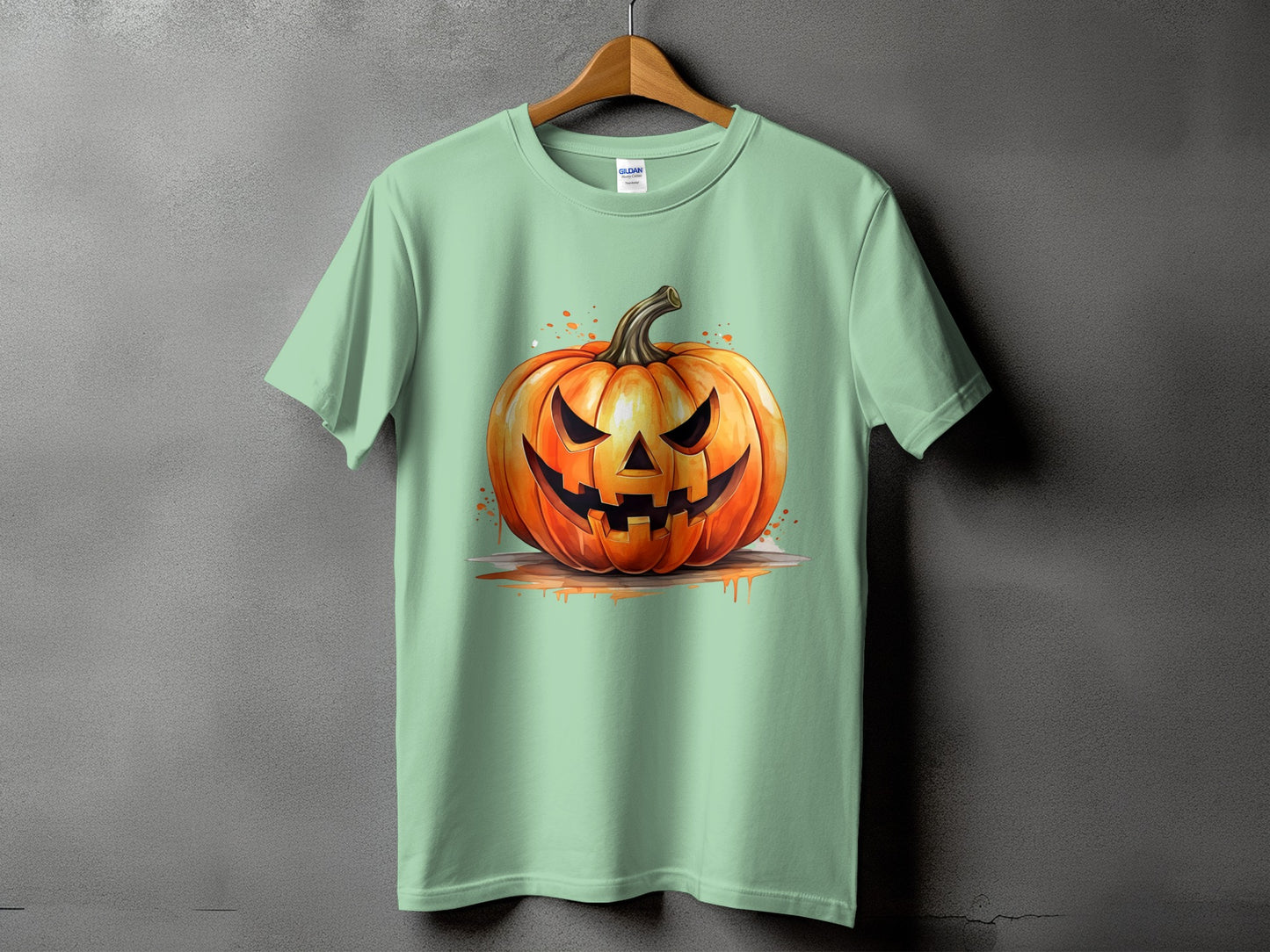 Mint green t-shirt with a watercolor jack-o'-lantern graphic design.