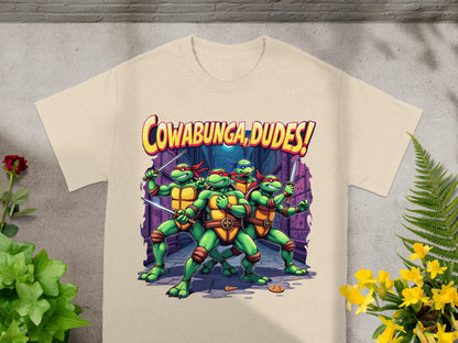 Teenage Mutant Ninja Turtles with swords and text "Cowabunga, Dudes!" on a t-shirt.