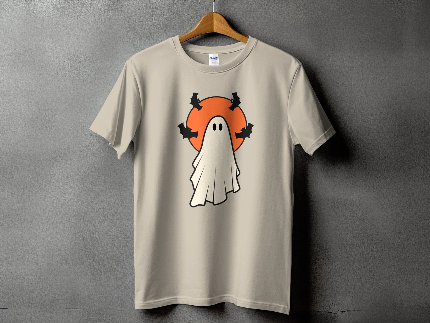Light beige t-shirt with a white ghost, orange circle, and black bats graphic.