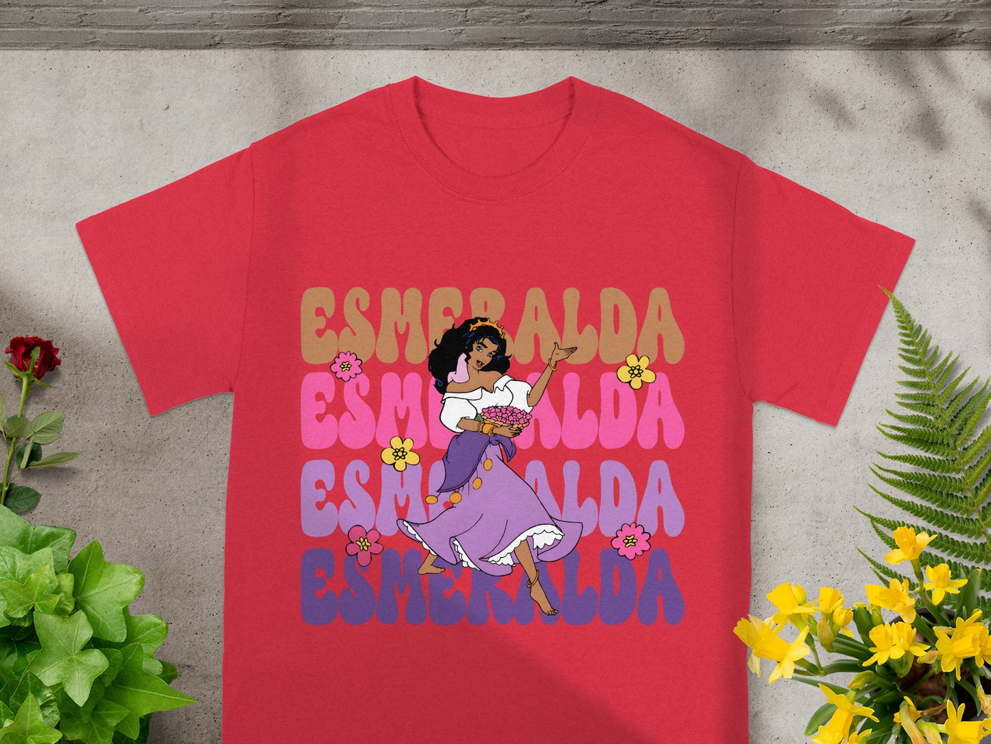 Red t-shirt with Esmeralda dancing and holding flowers.