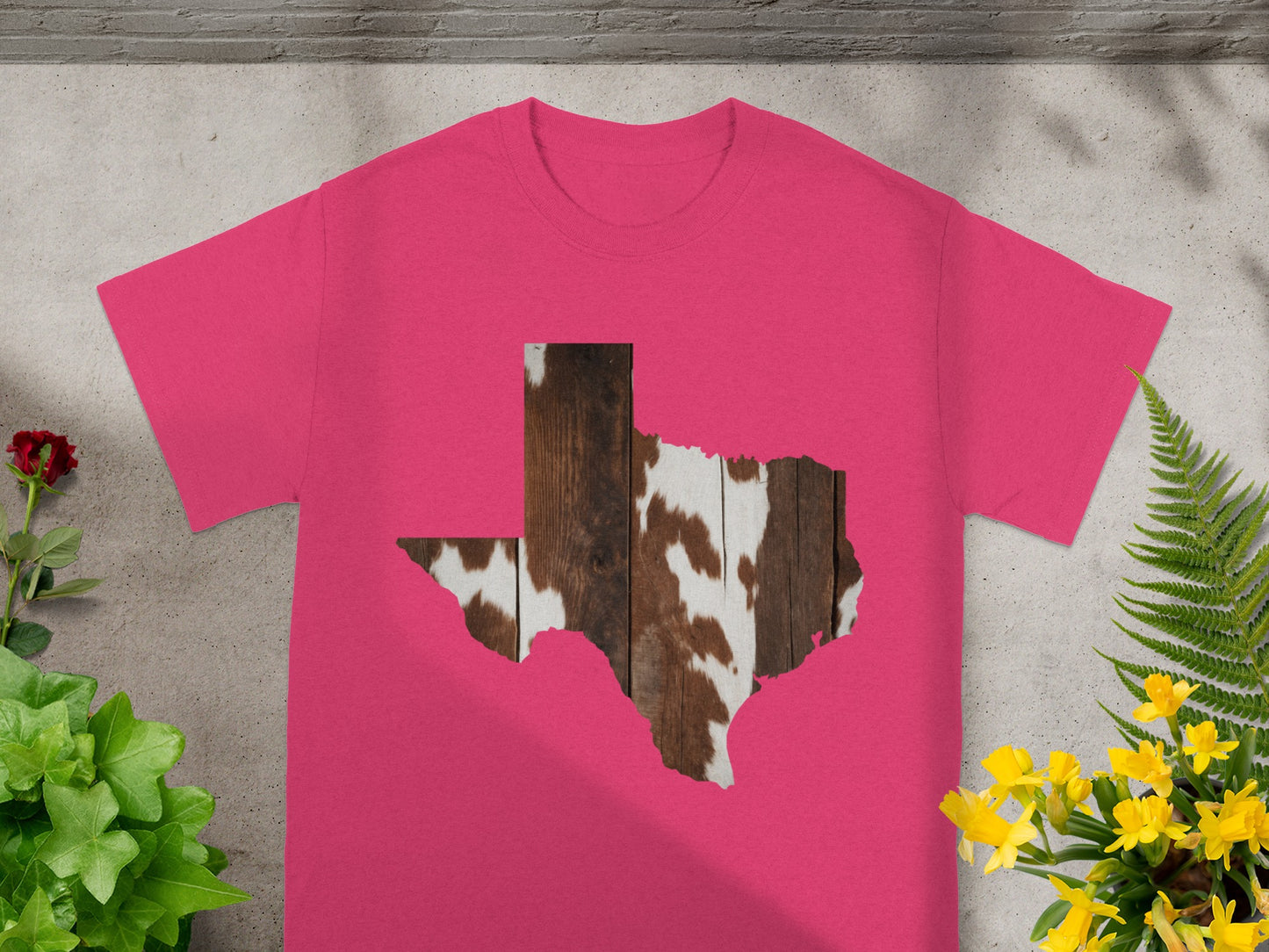 Pink t-shirt with Texas shape filled with wood and cowhide pattern.