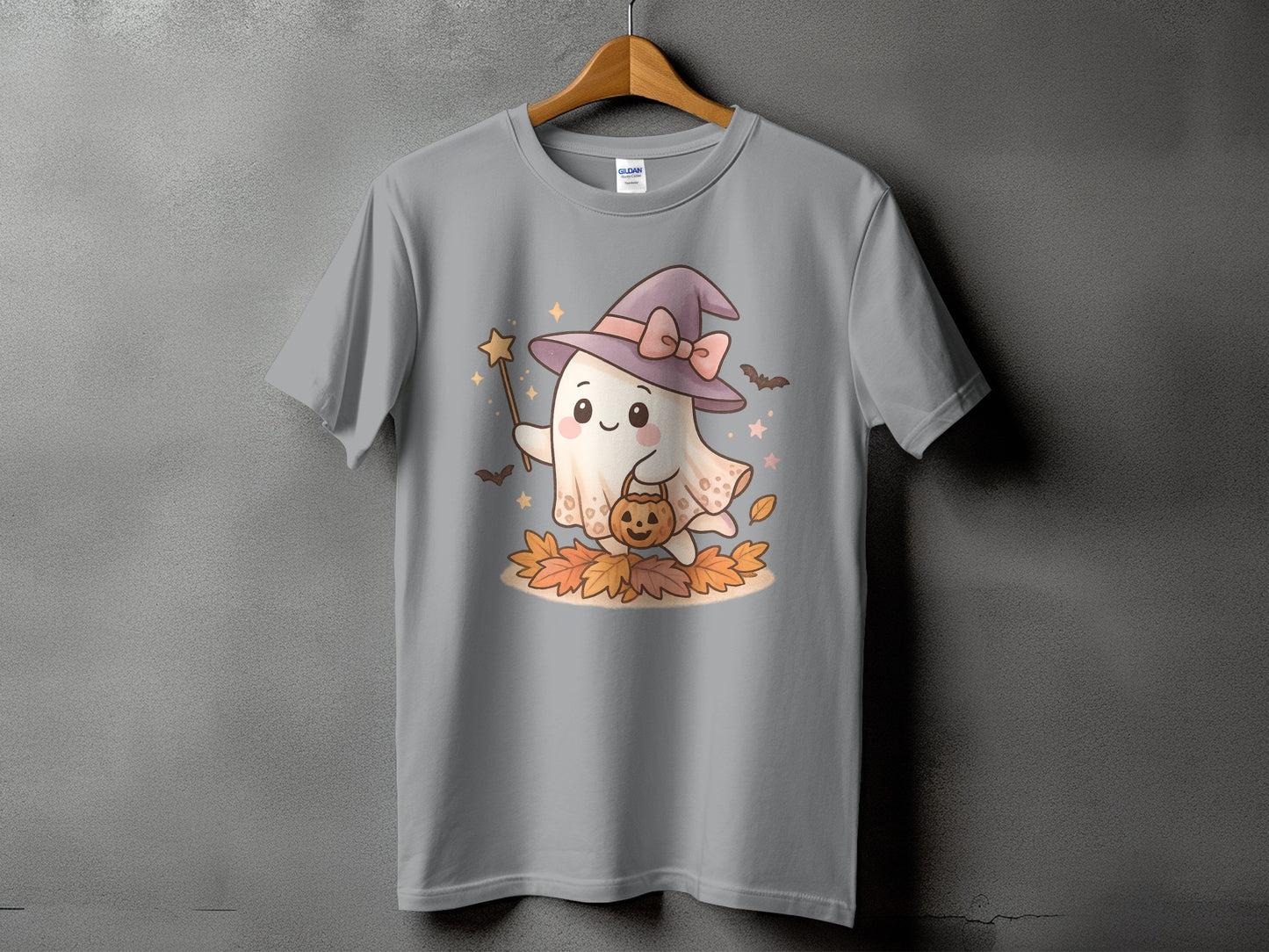 Grey t-shirt with a cute ghost in a witch hat holding a pumpkin and magic wand.