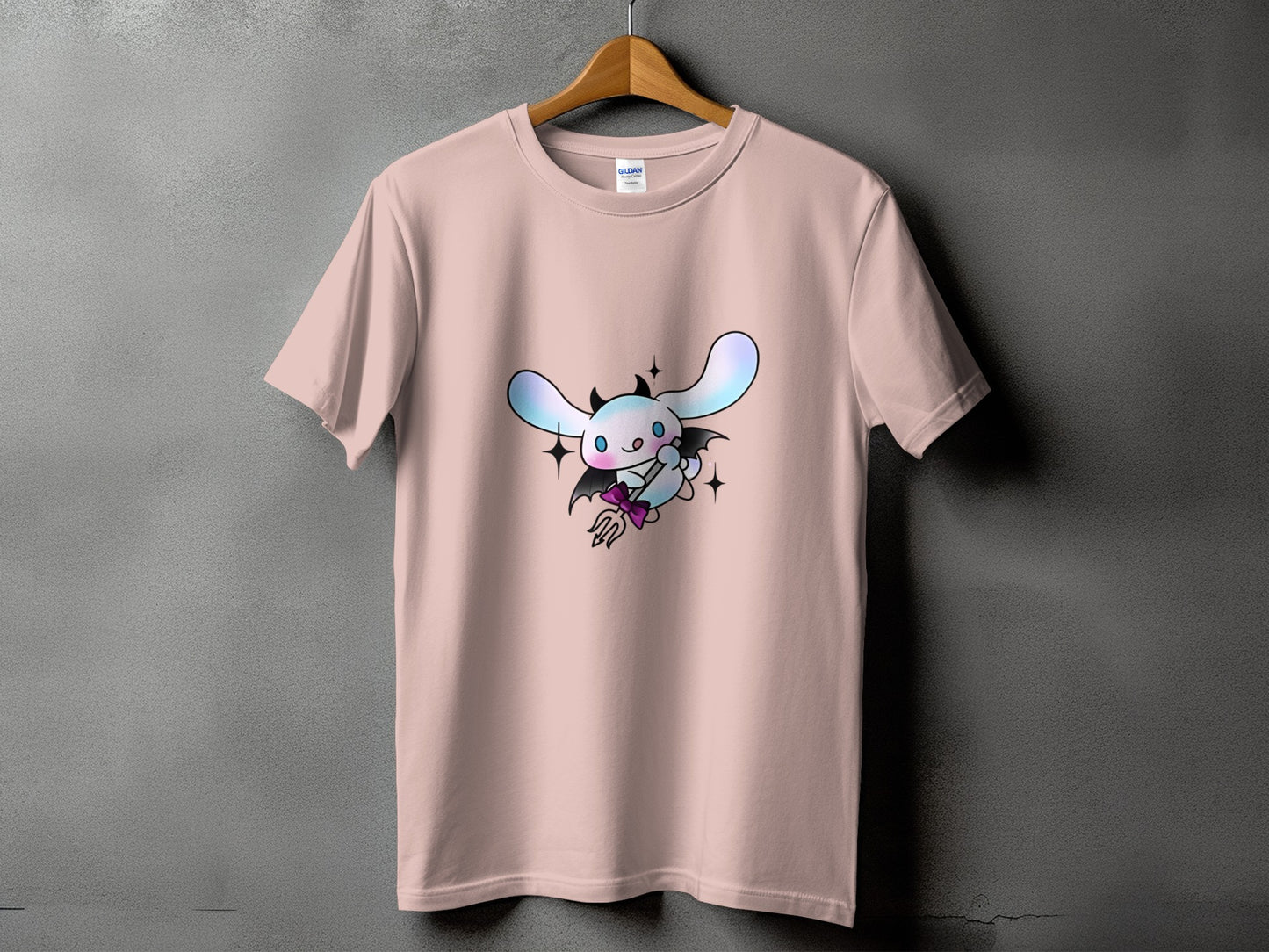 Pink t-shirt with a cartoon devil bunny holding a pitchfork.