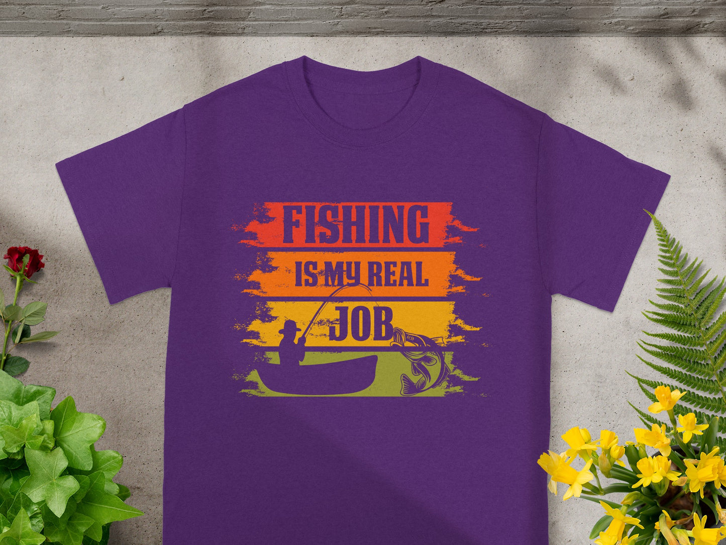 Purple t-shirt with "FISHING IS MY REAL JOB" text and fishing graphic.