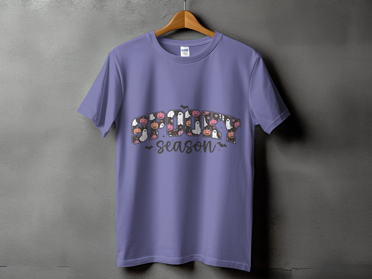 Purple t-shirt with "Spooky Season" text featuring Halloween imagery.