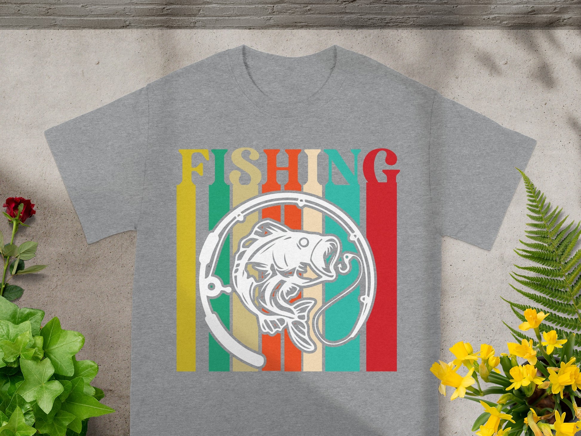 Grey t-shirt with "FISHING" text above a fish illustration with fishing rod and colorful stripes.