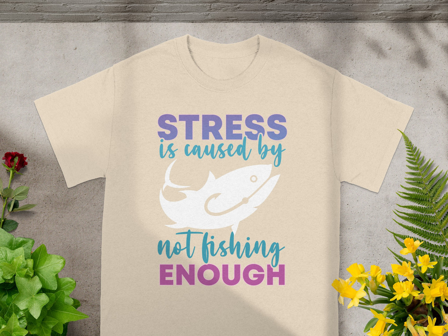 T-shirt with text "STRESS is caused by not fishing ENOUGH" and a fish graphic.