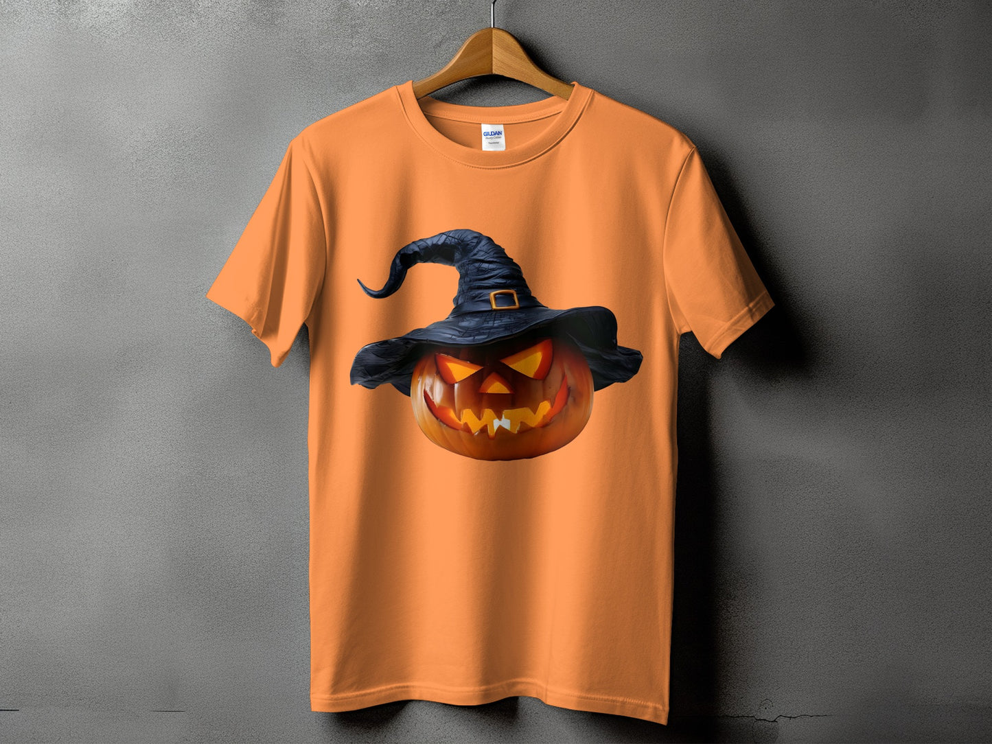 Orange t-shirt with a glowing jack-o'-lantern wearing a witch hat graphic.