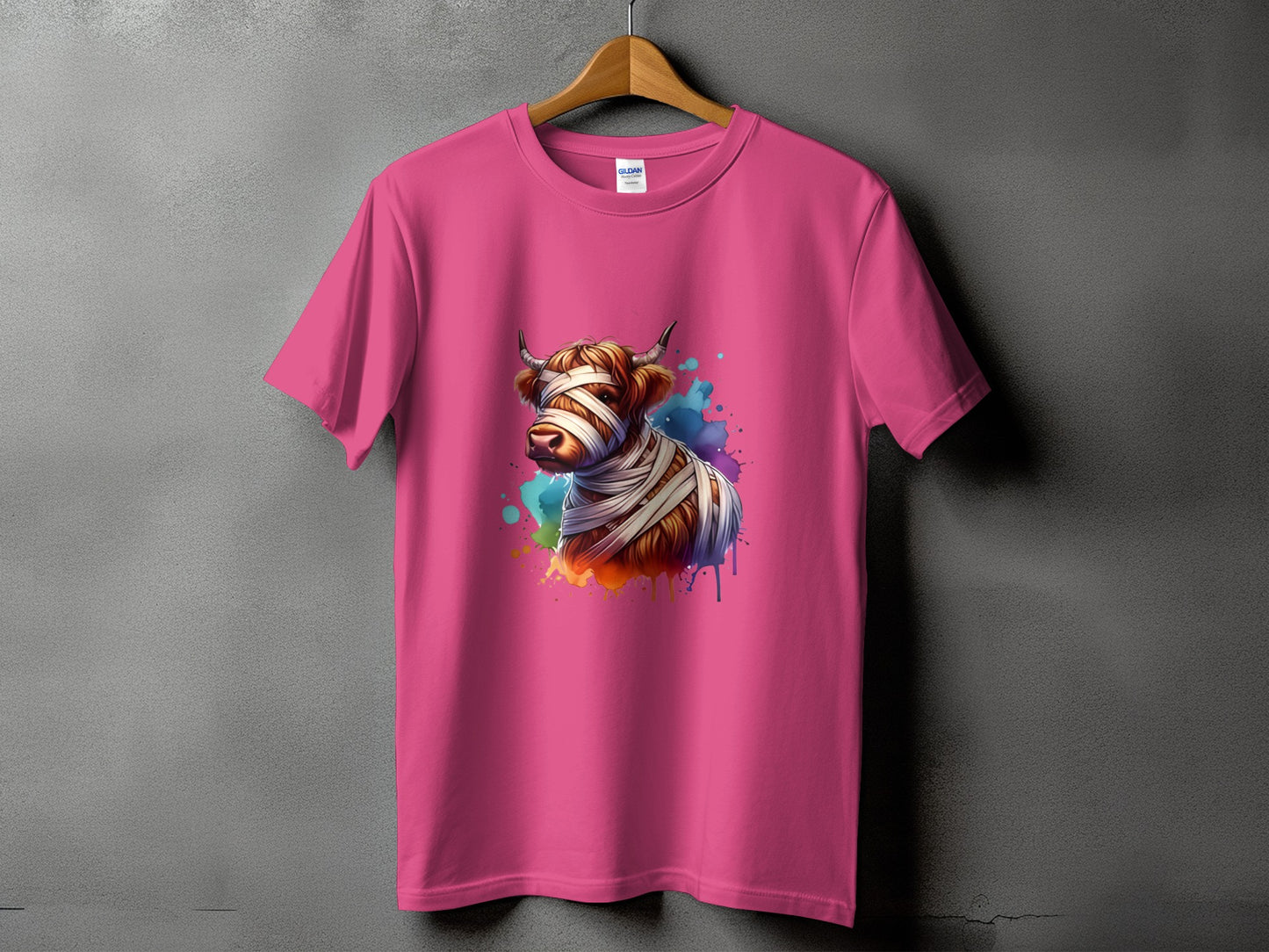 Pink t-shirt with a watercolor mummy cow graphic and colorful paint splatters.