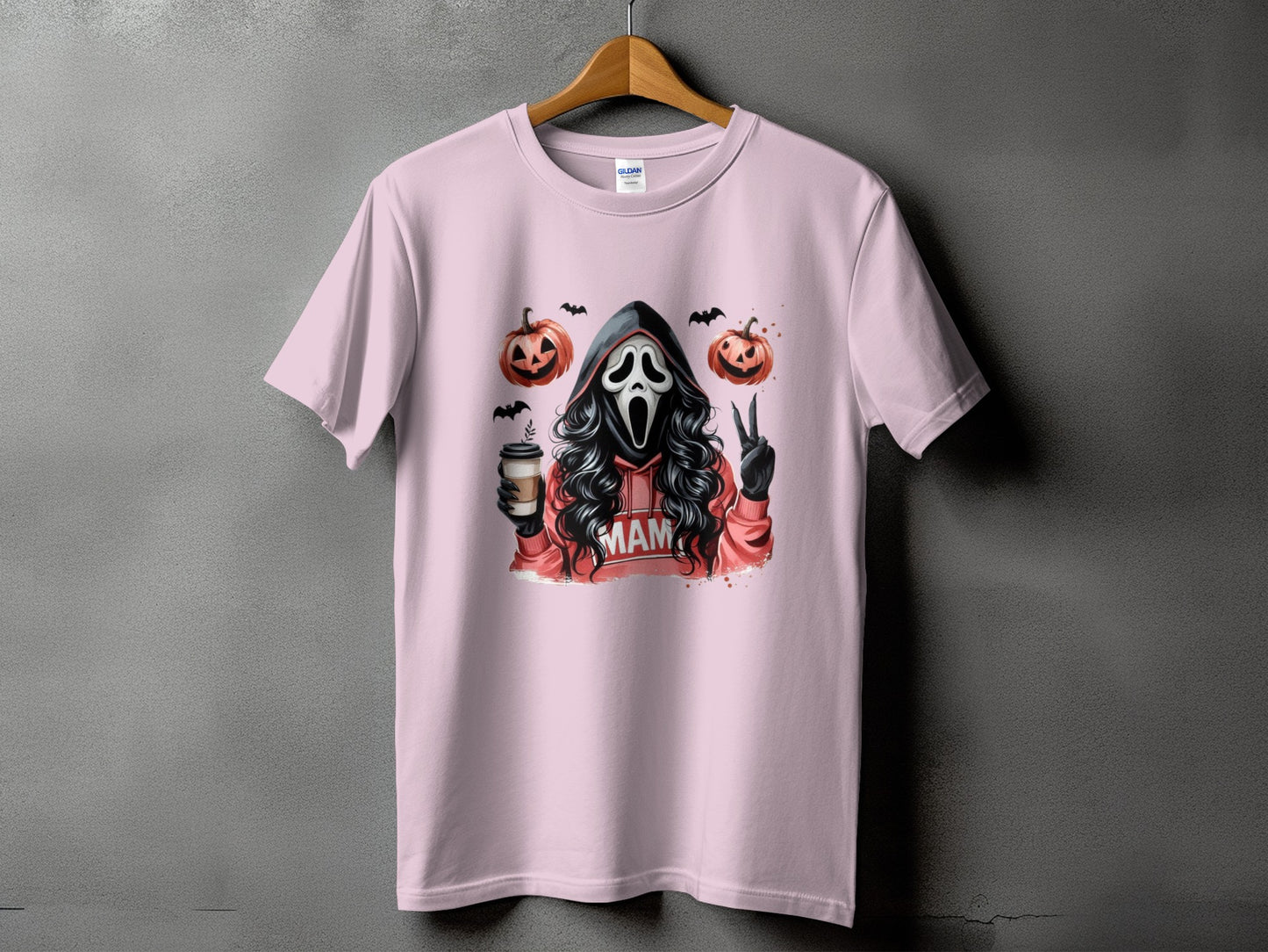 Pink t-shirt with ghost face, pumpkins, bats, coffee cup, and "MAM" text.