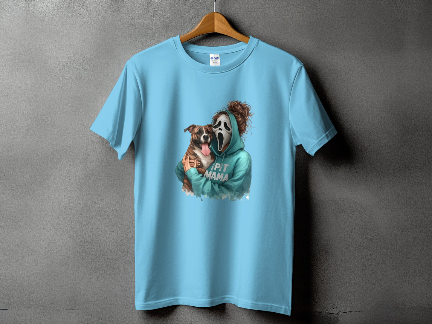 Light blue t-shirt with a ghost face mask and dog graphic, reads "Pit Mama".