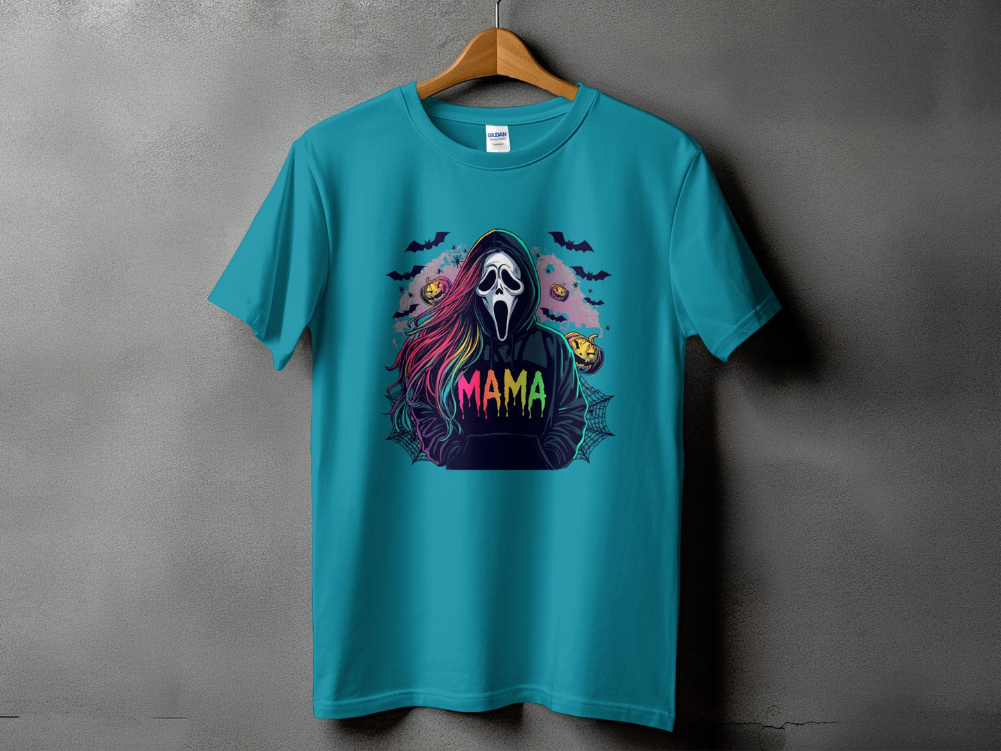 Teal t-shirt with a spooky graphic featuring the word "MAMA" and a ghost face.