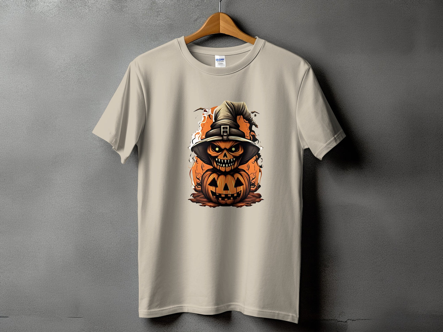 Light tan t-shirt with a jack-o'-lantern wearing a witch hat and glowing eyes graphic.