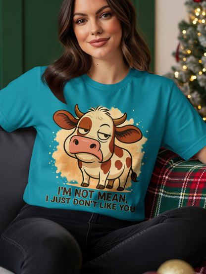 Teal t-shirt with a cartoon cow and text "I'M NOT MEAN, I JUST DON'T LIKE YOU".