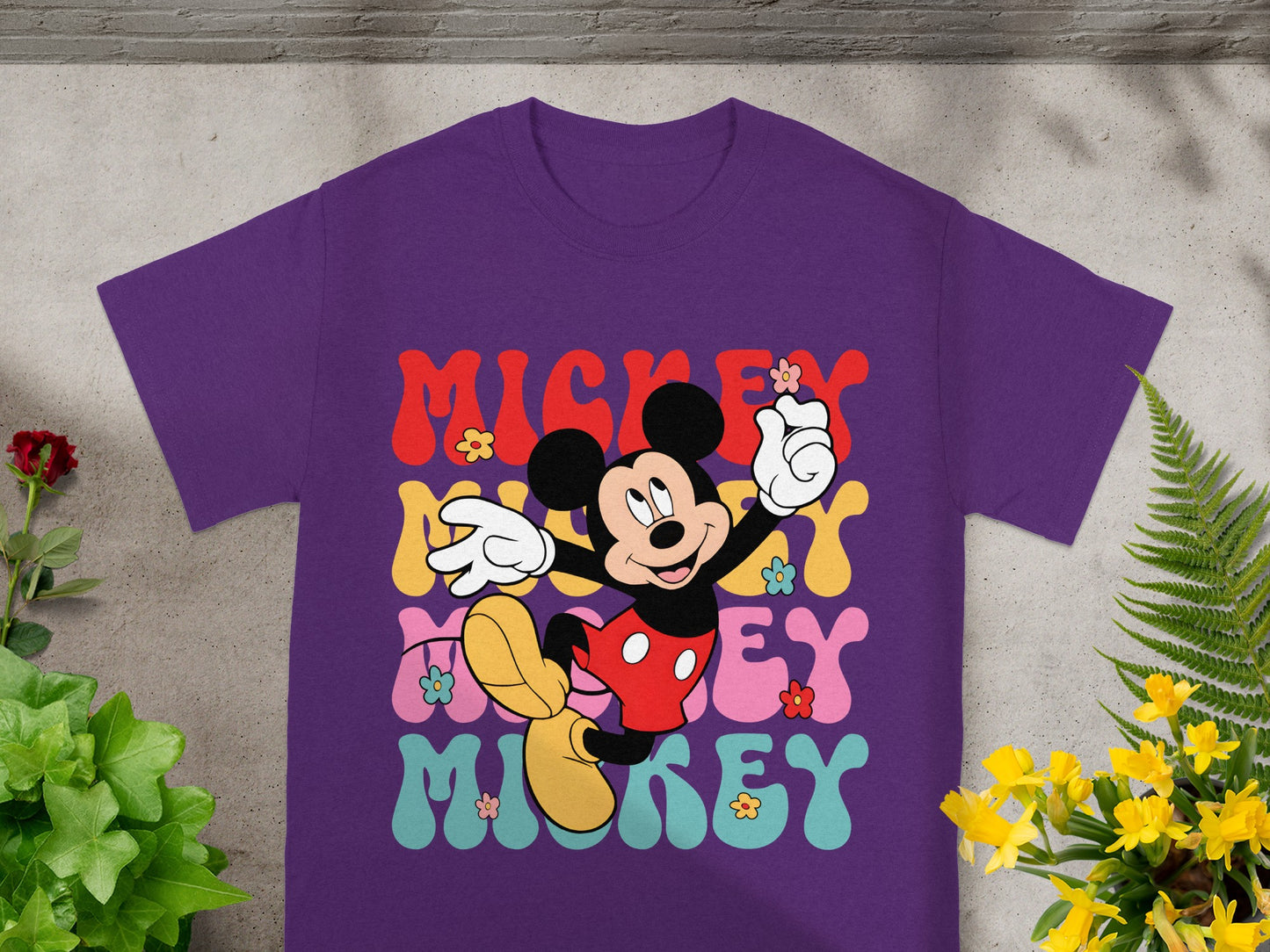 Purple t-shirt with retro Mickey Mouse graphic and colorful "Mickey" text.