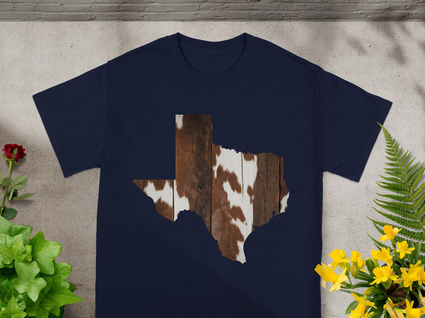Navy t-shirt with Texas outline filled with wood grain and cowhide pattern.