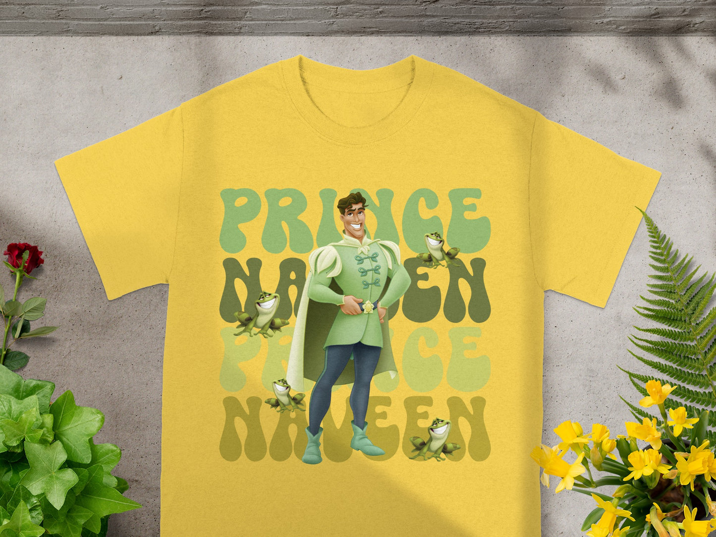 Yellow t-shirt with Prince charming and frogs graphic design.