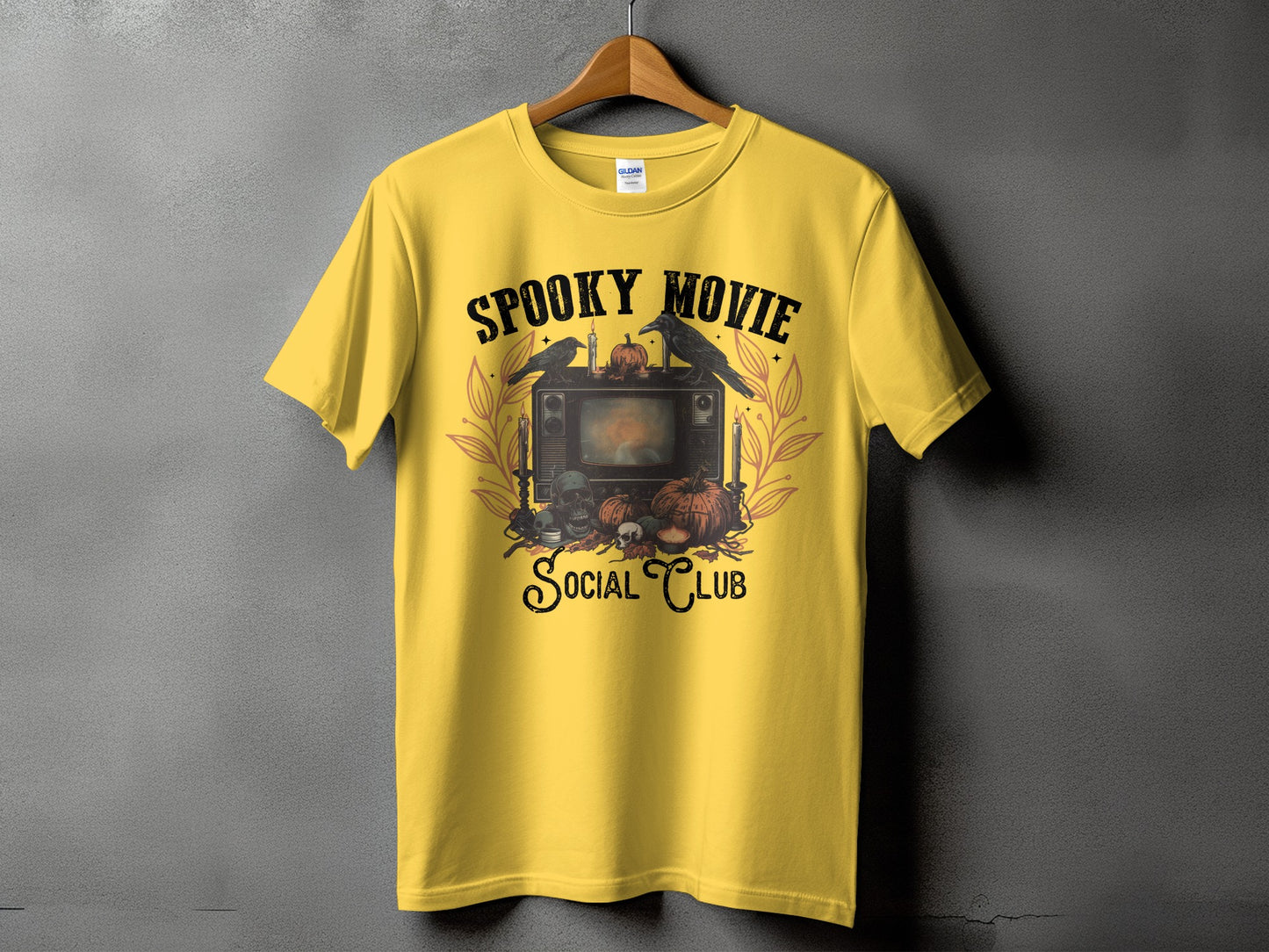 Yellow t-shirt with "Spooky Movie Social Club" text and Halloween-themed graphic.