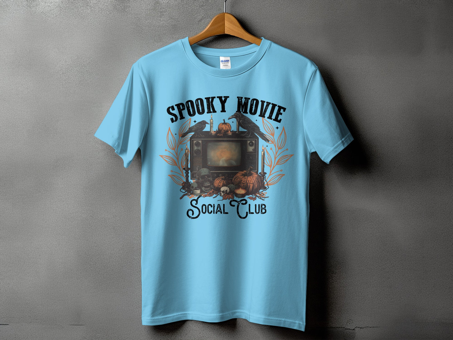 Light blue t-shirt with "Spooky Movie Social Club" Halloween graphic.