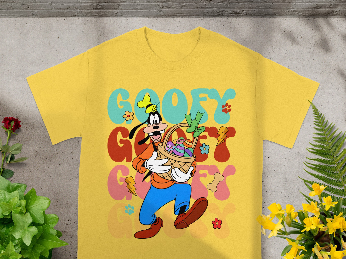 Yellow t-shirt with Goofy holding an Easter basket with colorful eggs.