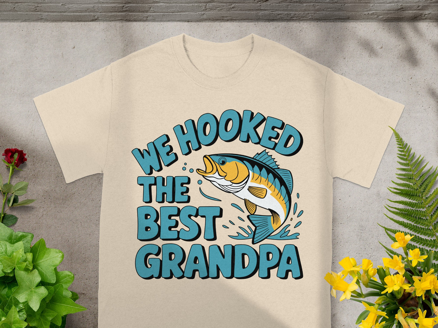 T-shirt with "WE HOOKED THE BEST GRANDPA" text and a jumping fish graphic.