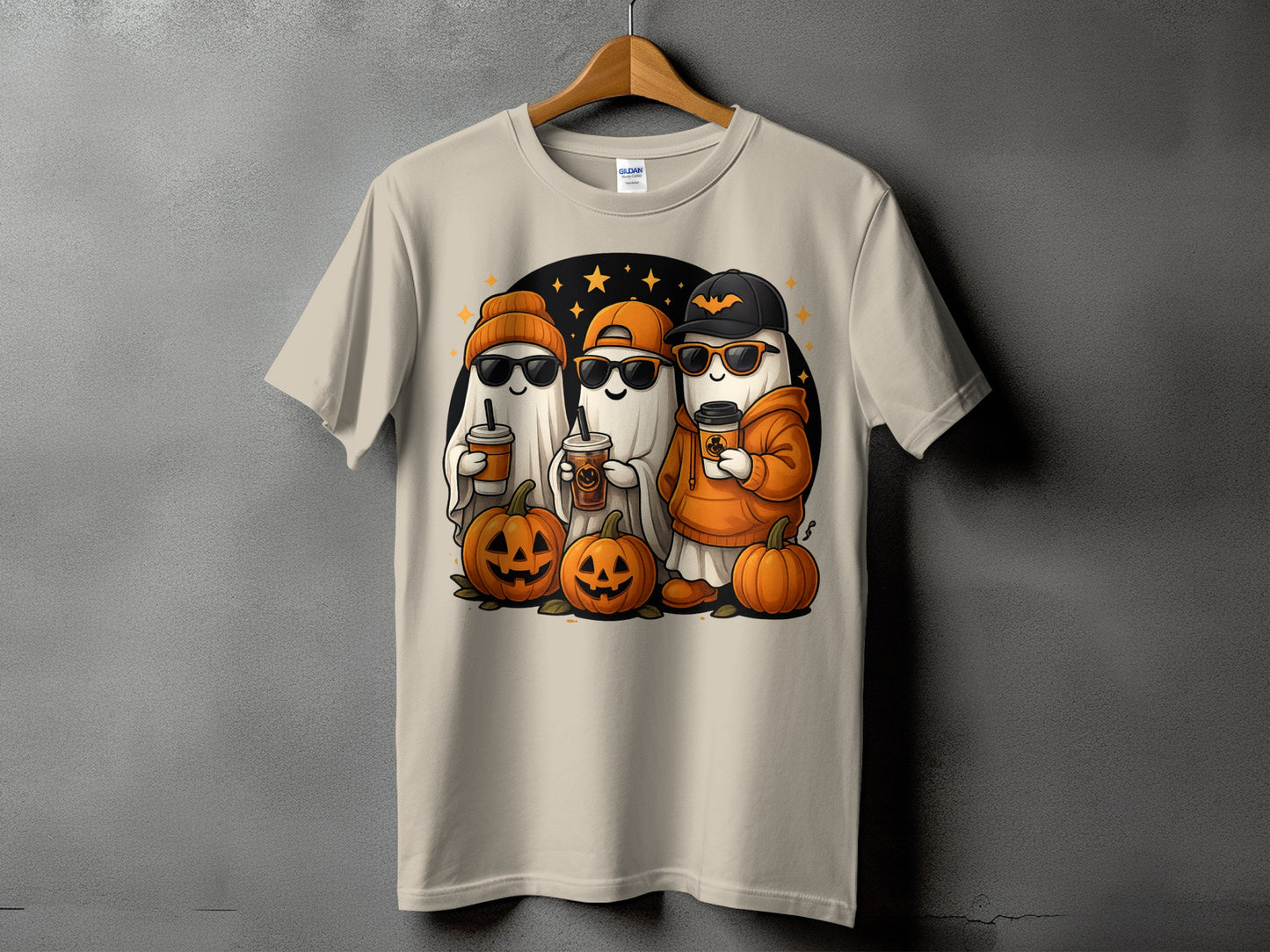 Three cute cartoon ghosts hold coffee cups with pumpkins on a t-shirt.
