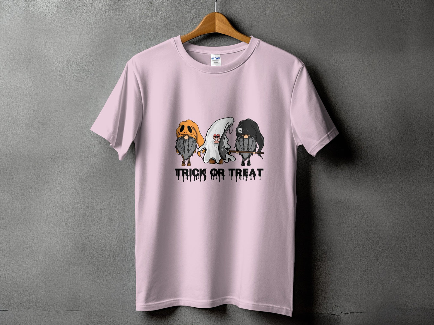Pink t-shirt with three Halloween gnomes and dripping text reading "TRICK OR TREAT".