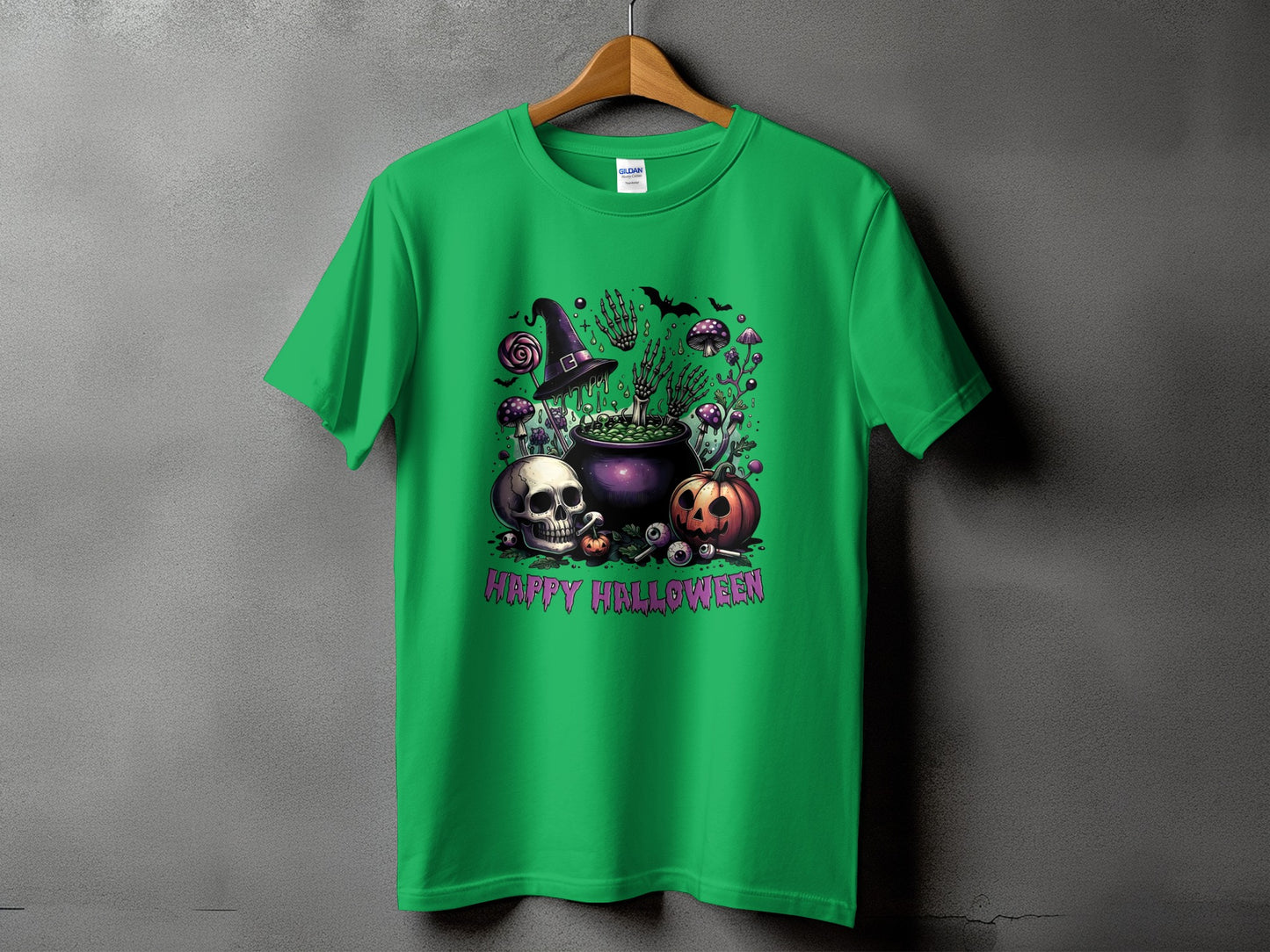 Green t-shirt with a Halloween graphic featuring a skull, pumpkin, cauldron, and skeletons.