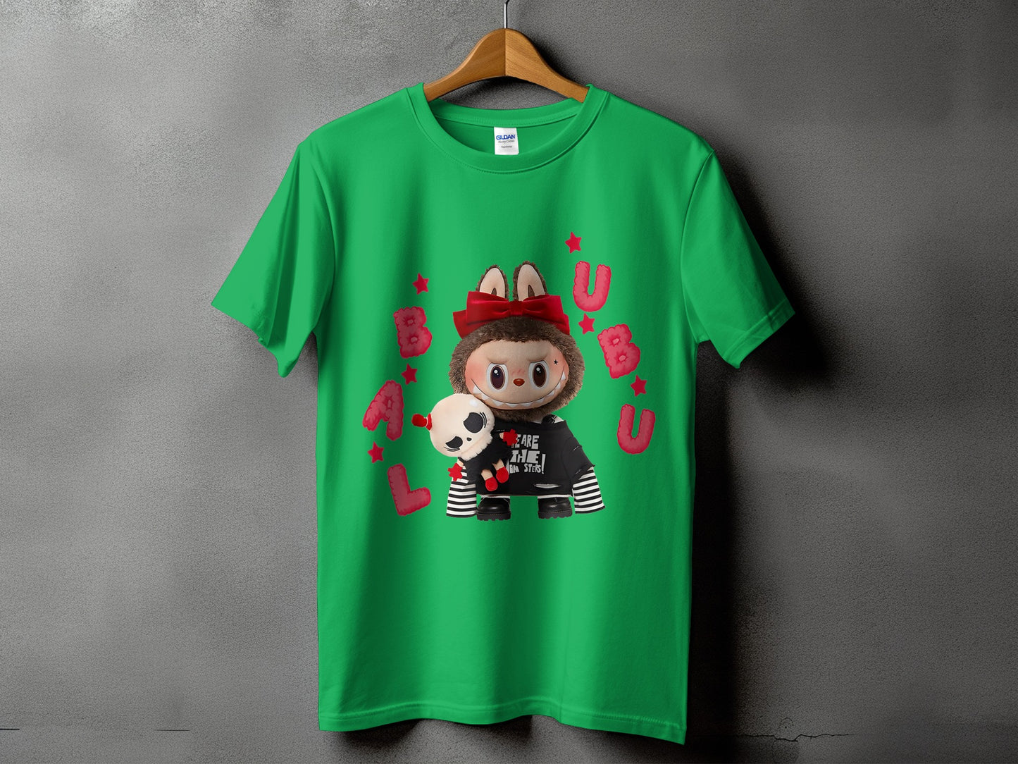 Green t-shirt with cartoon character holding a skull and text "BAU ARE THE MONSTERS".