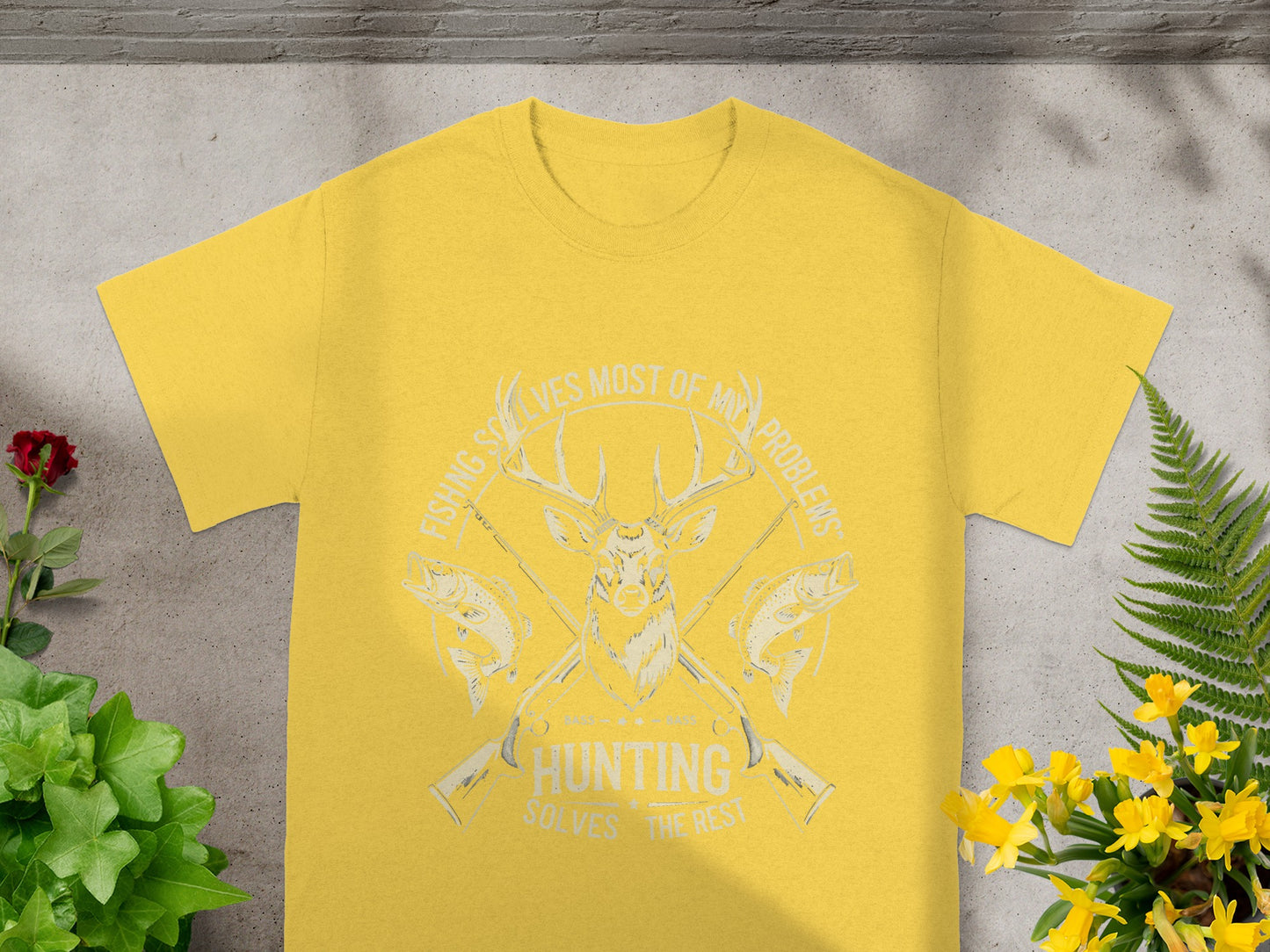 Yellow t-shirt with deer, fish, and guns graphic, reading "Fishing solves most of my problems, hunting solves the rest."
