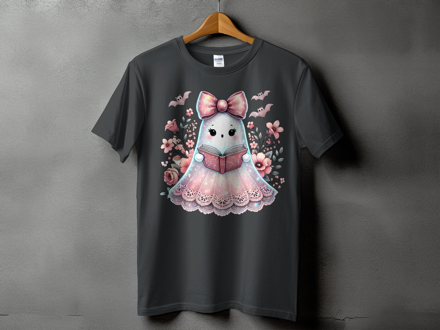Gray t-shirt with a cute ghost reading a book, surrounded by flowers and bats.