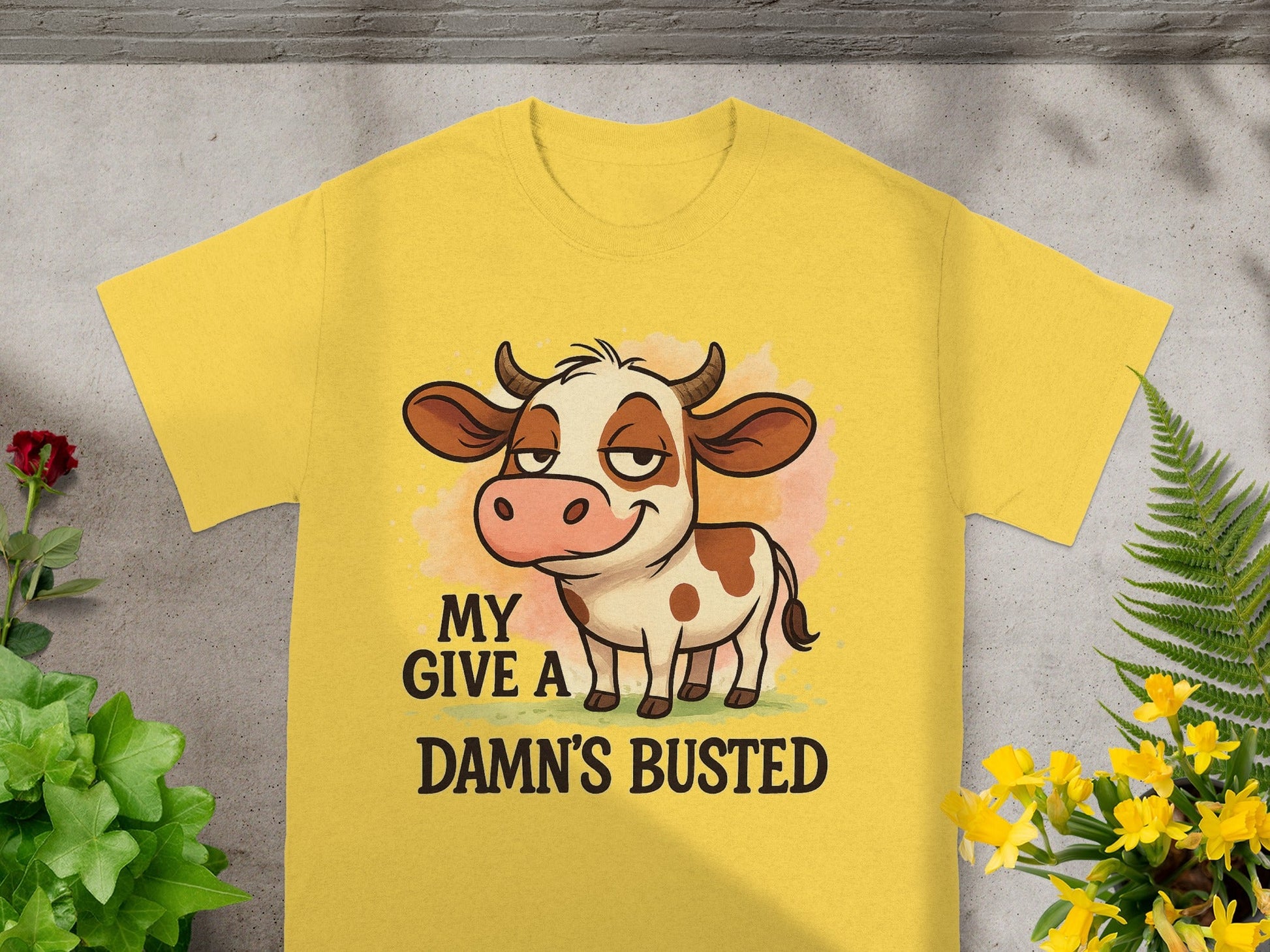 Yellow t-shirt with cartoon cow and "My Damn's Busted" text.