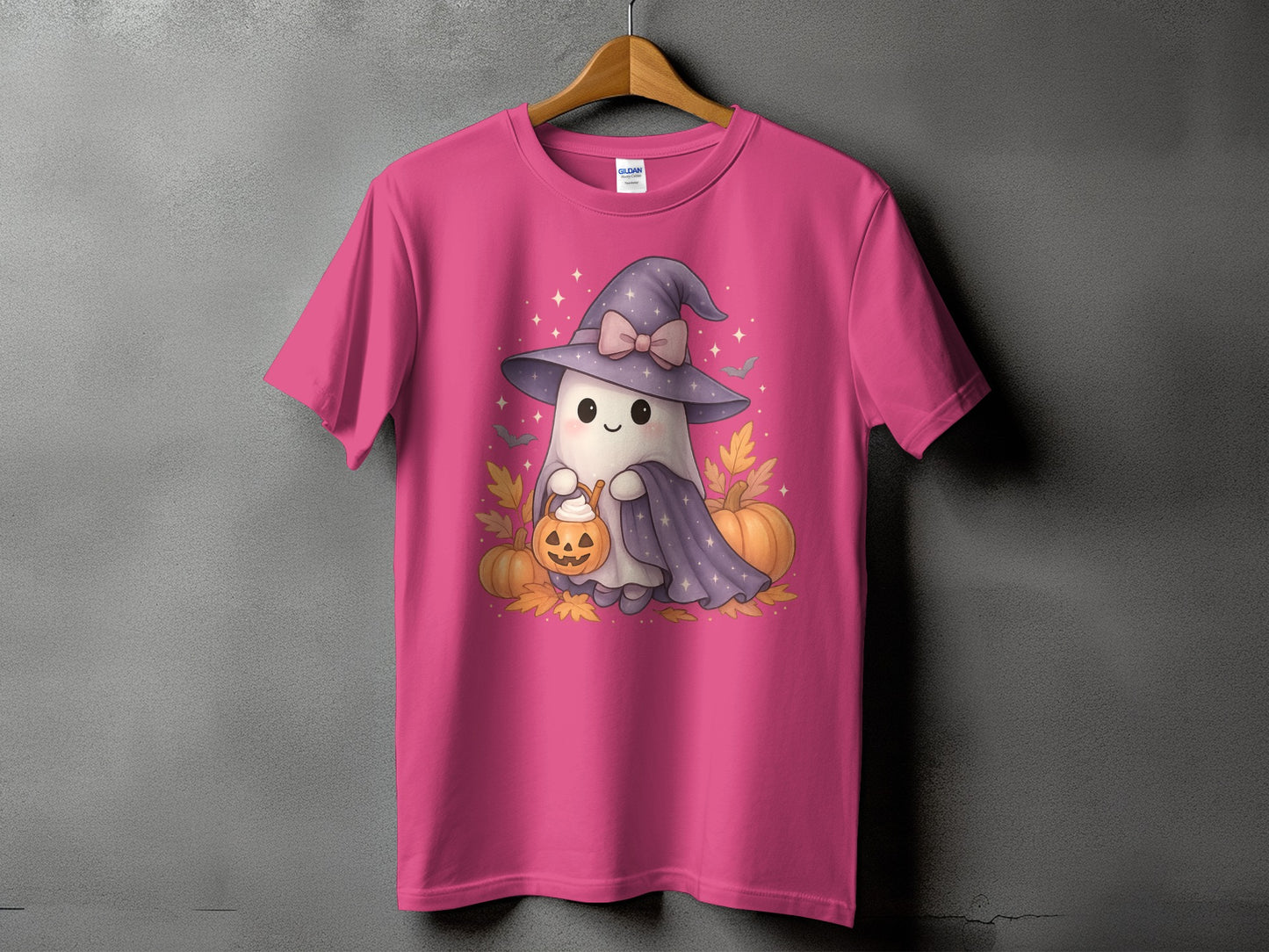 Pink t-shirt with a cute ghost wearing a witch hat and holding a pumpkin.