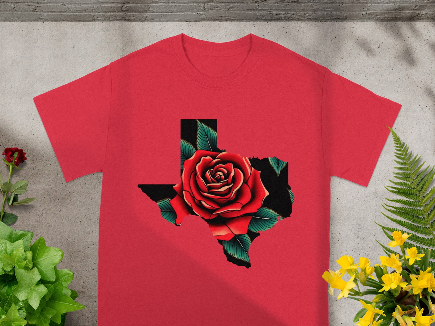 Red t-shirt with a Texas shape filled with a red rose and green leaves.