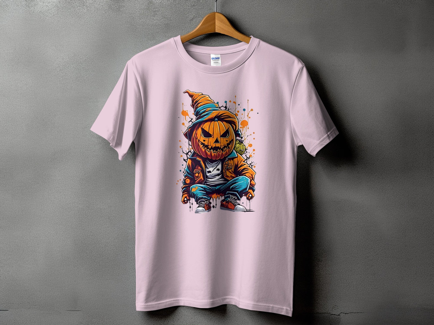 Pink t-shirt with graphic of a crouching jack-o-lantern character.