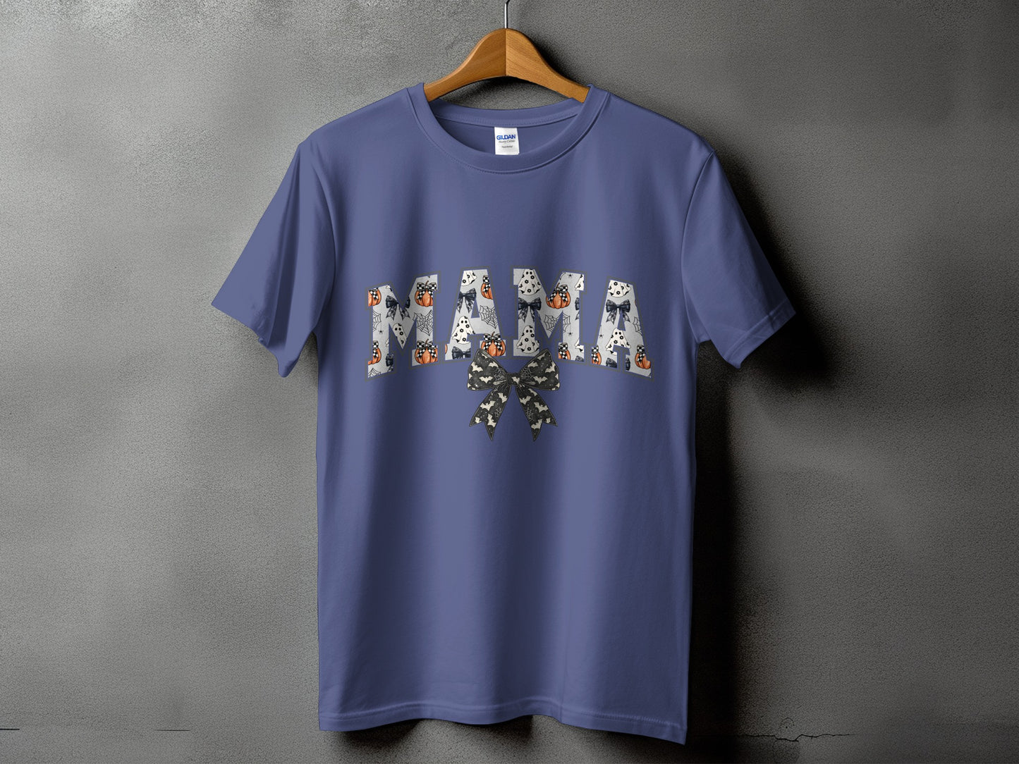 Purple t-shirt with "MAMA" text featuring Halloween motifs and a bow.