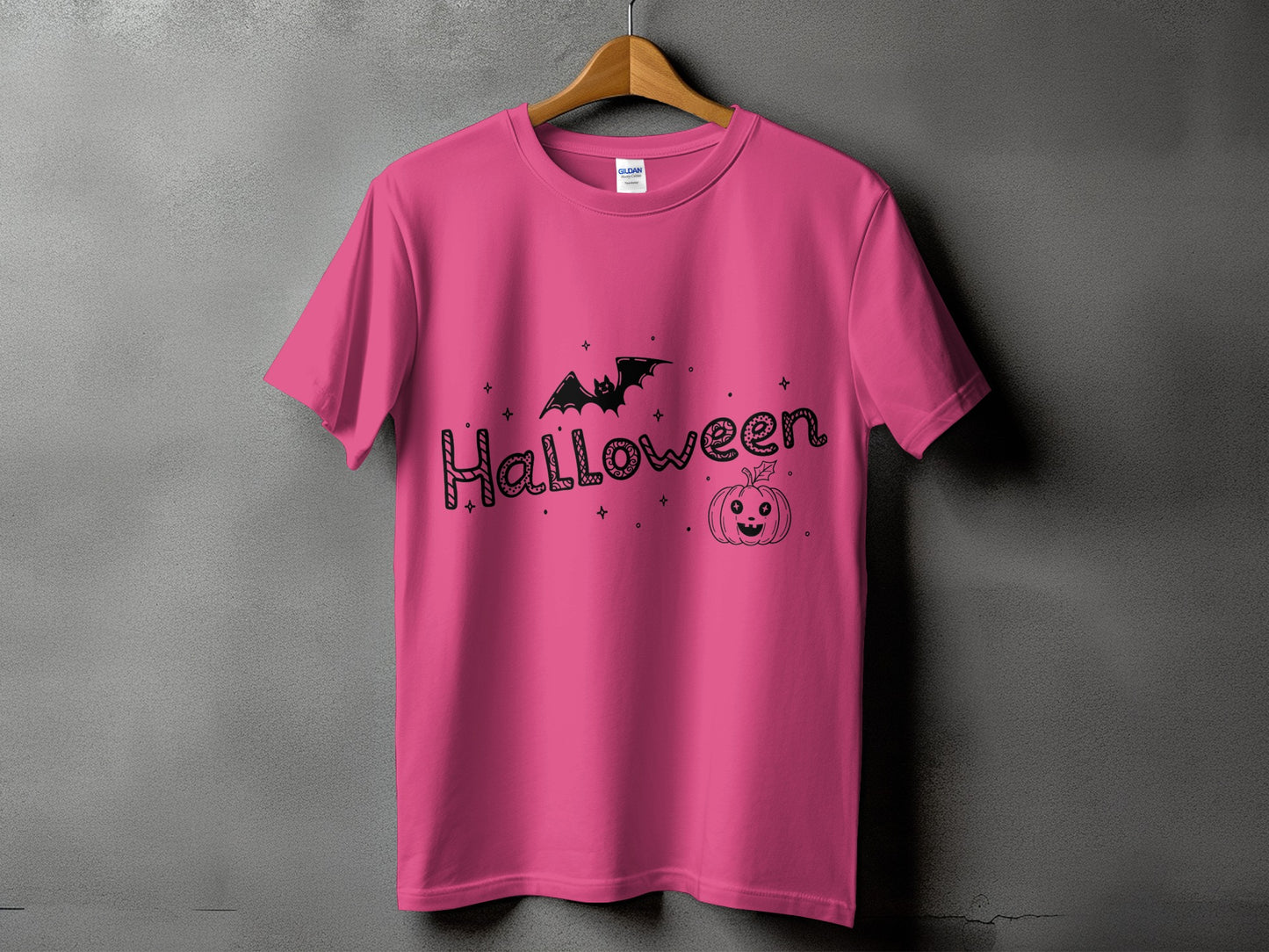 Pink t-shirt with black Halloween graphic featuring bat and pumpkin.