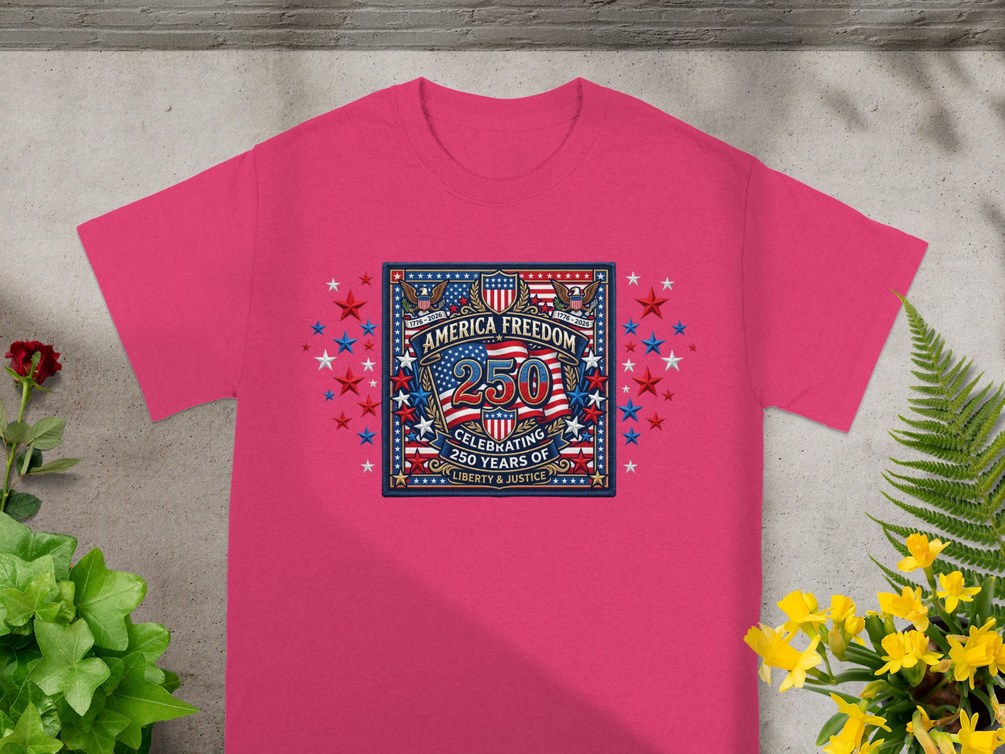 Pink t-shirt featuring "America Celebrating 250 Years Liberty & Justice" emblem.