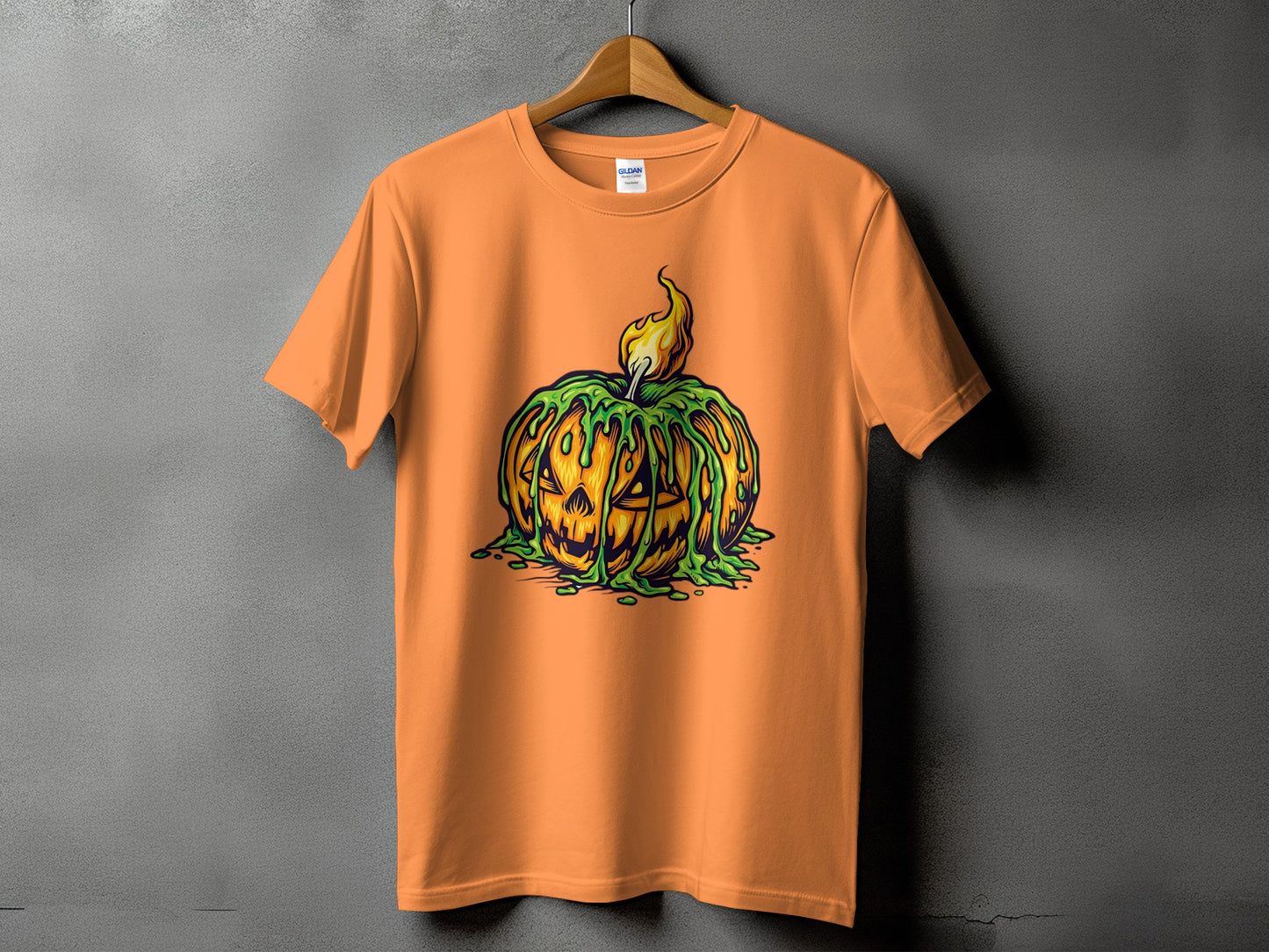 Orange t-shirt featuring a jack-o'-lantern with dripping green slime and a flame.