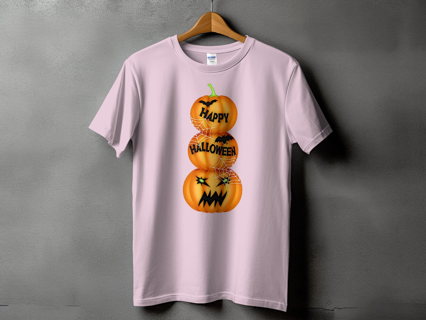 Pink t-shirt with stacked pumpkins saying "Happy Halloween" with bats and cobwebs.