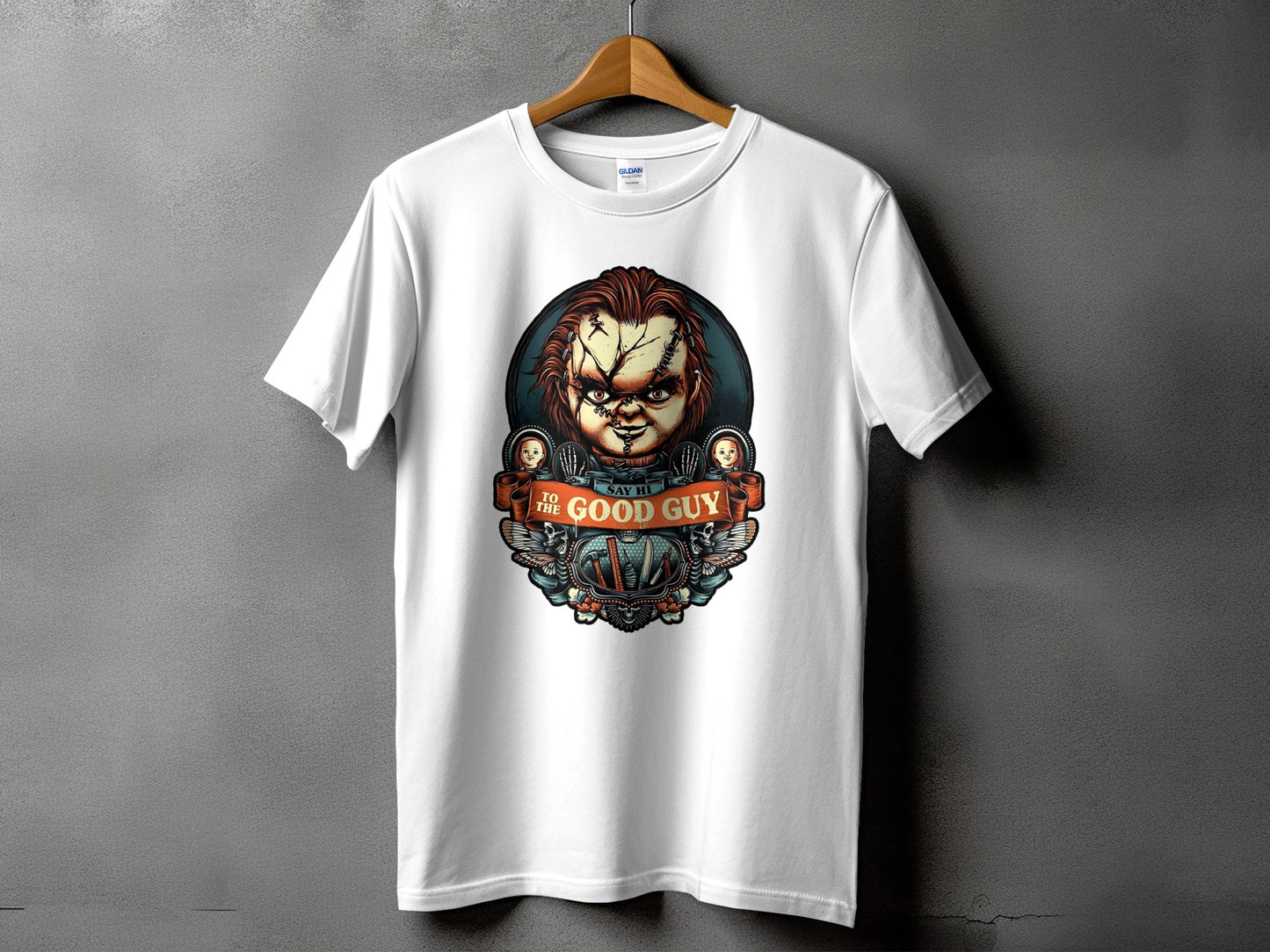 White t-shirt featuring Chucky from Child's Play with "Say Hi To The Good Guy" text.