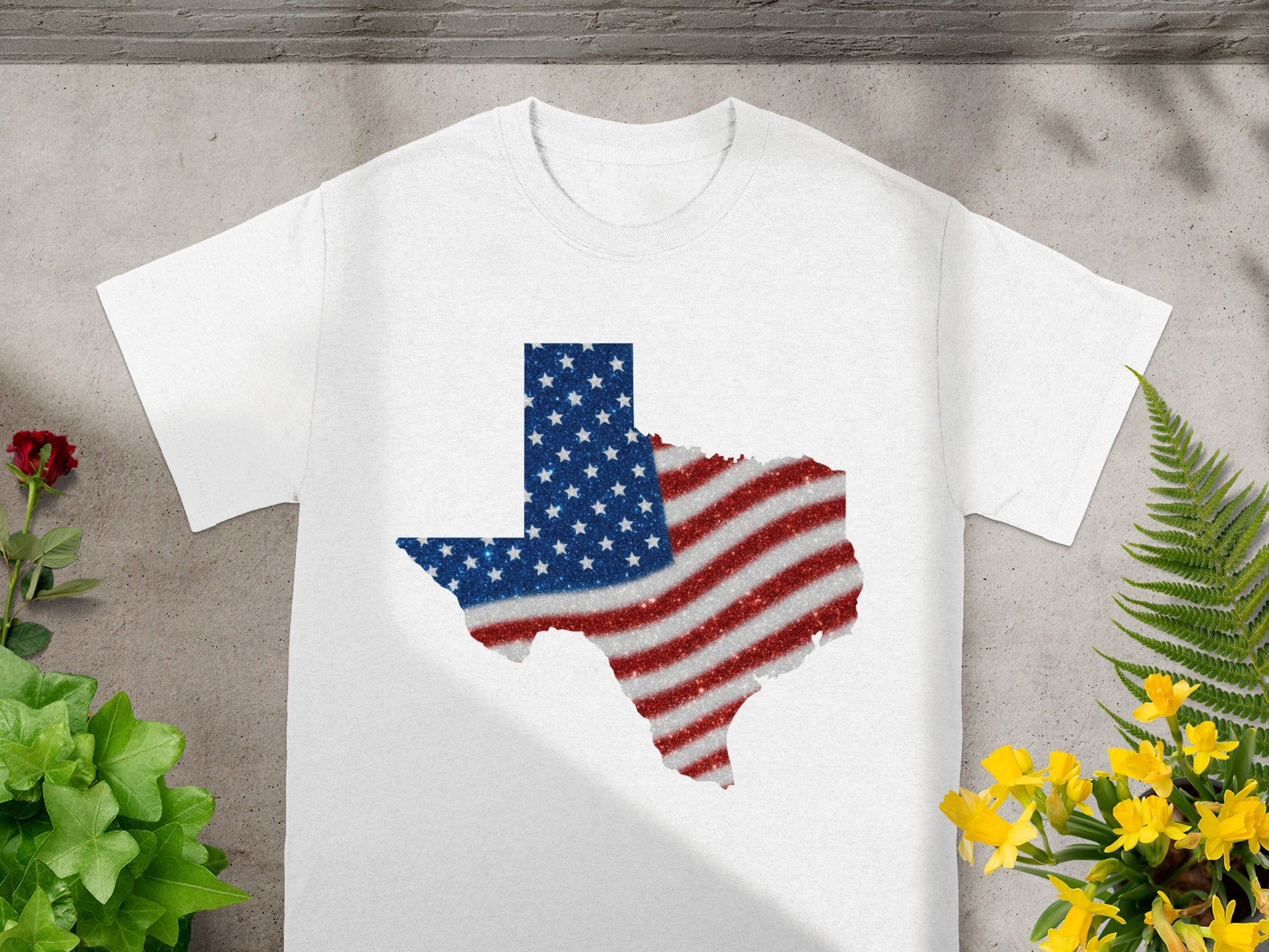 White t-shirt with Texas outline filled with glitter American flag design.