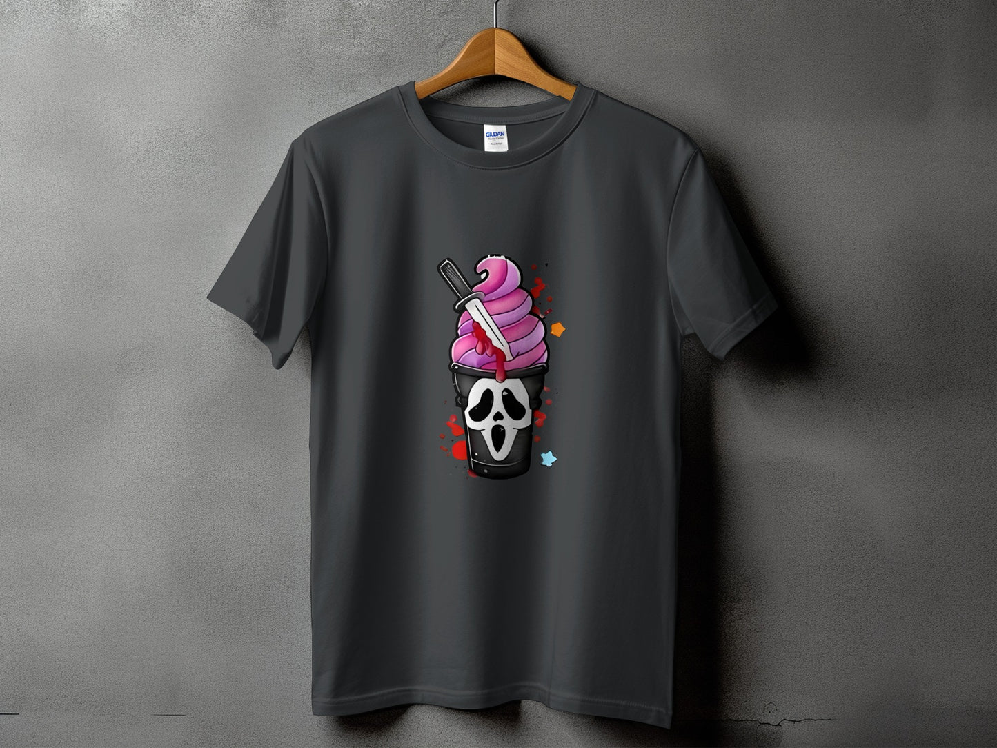 Dark t-shirt with a graphic of a screaming ghost face cup with pink ice cream and a knife.