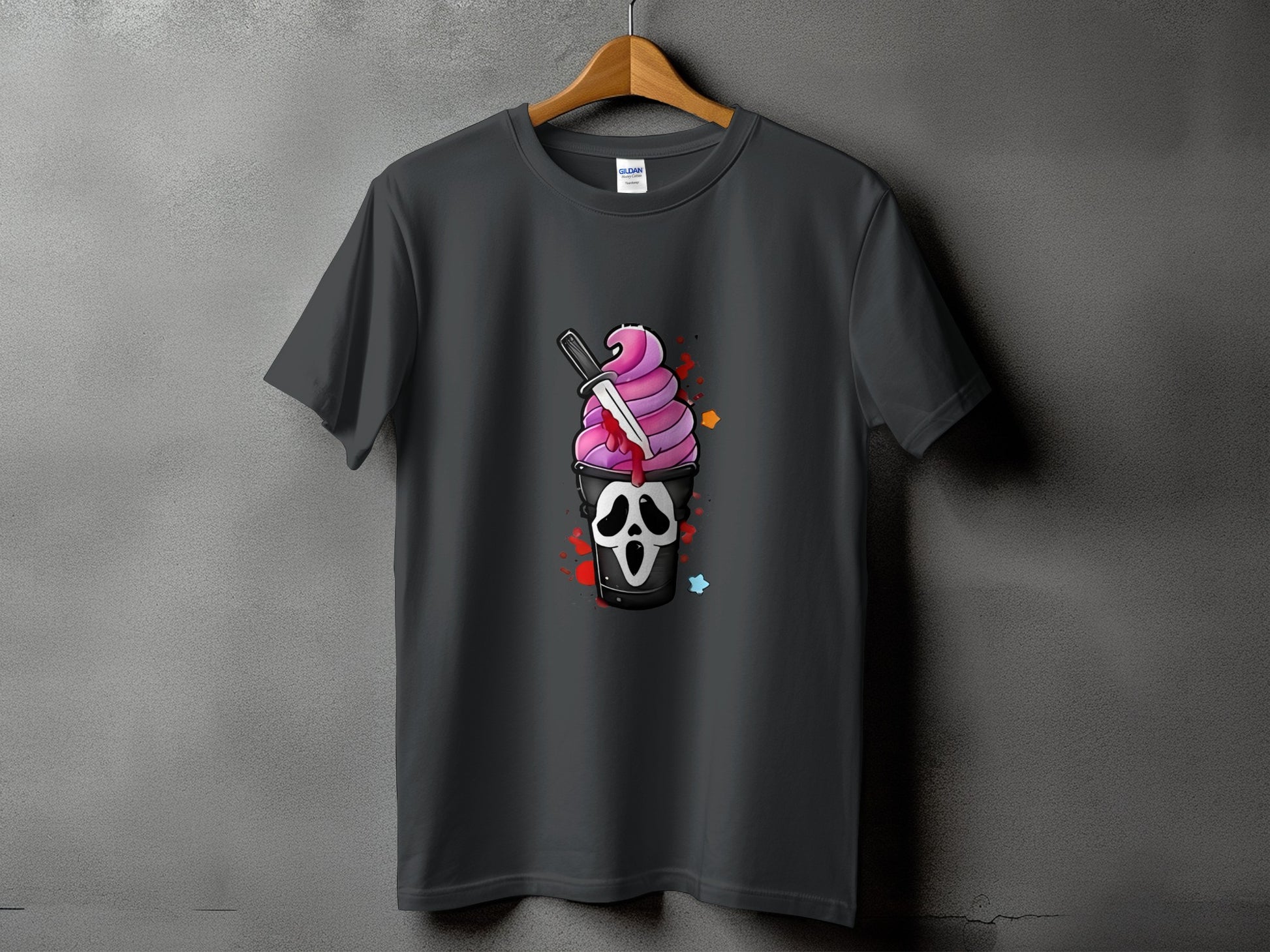 Dark t-shirt with a graphic of a screaming ghost face cup with pink ice cream and a knife.