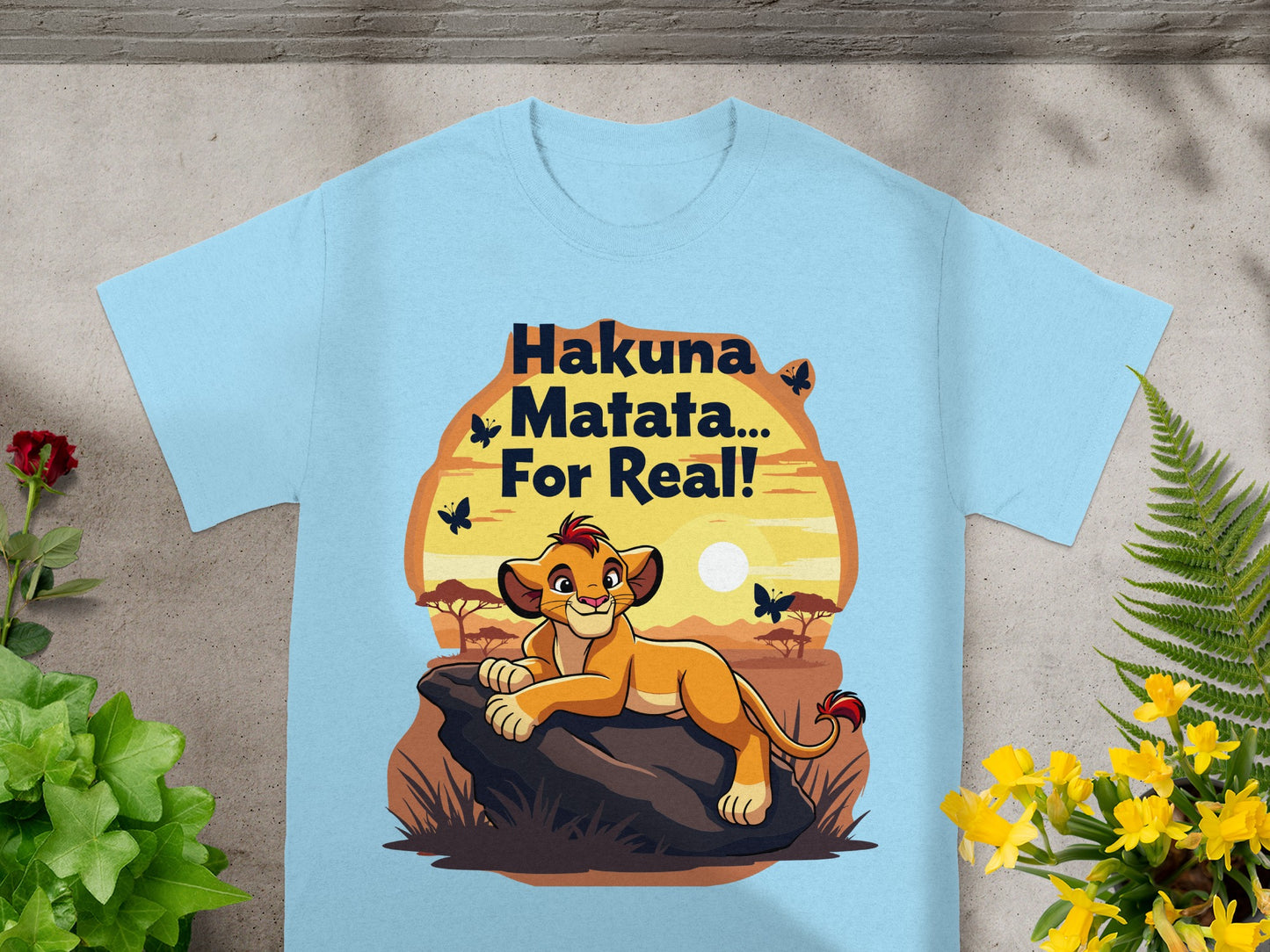 Light blue t-shirt with Simba from The Lion King saying "Hakuna Matata... For Real!".