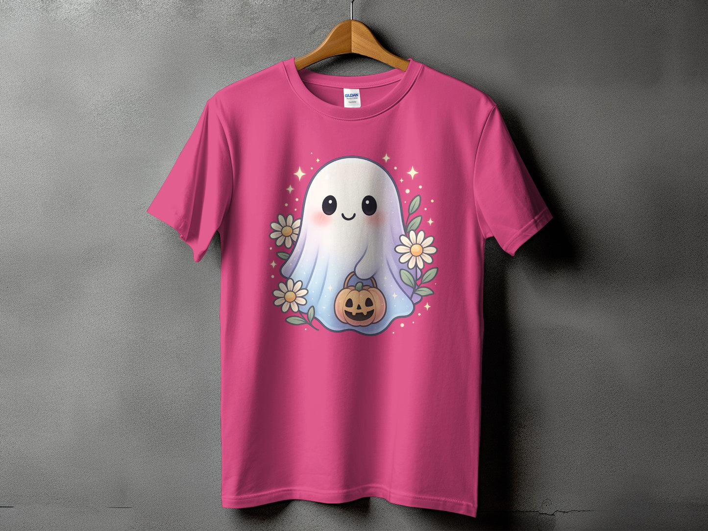Pink t-shirt with a cute ghost holding a jack-o'-lantern, surrounded by flowers.