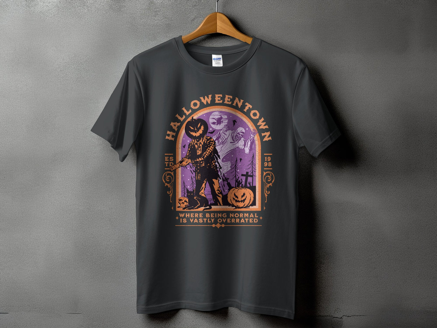 Dark grey t-shirt with a Halloween graphic and the text "HALLOWEENTOWN WHERE BEING NORMAL IS VASTLY OVERRATED".
