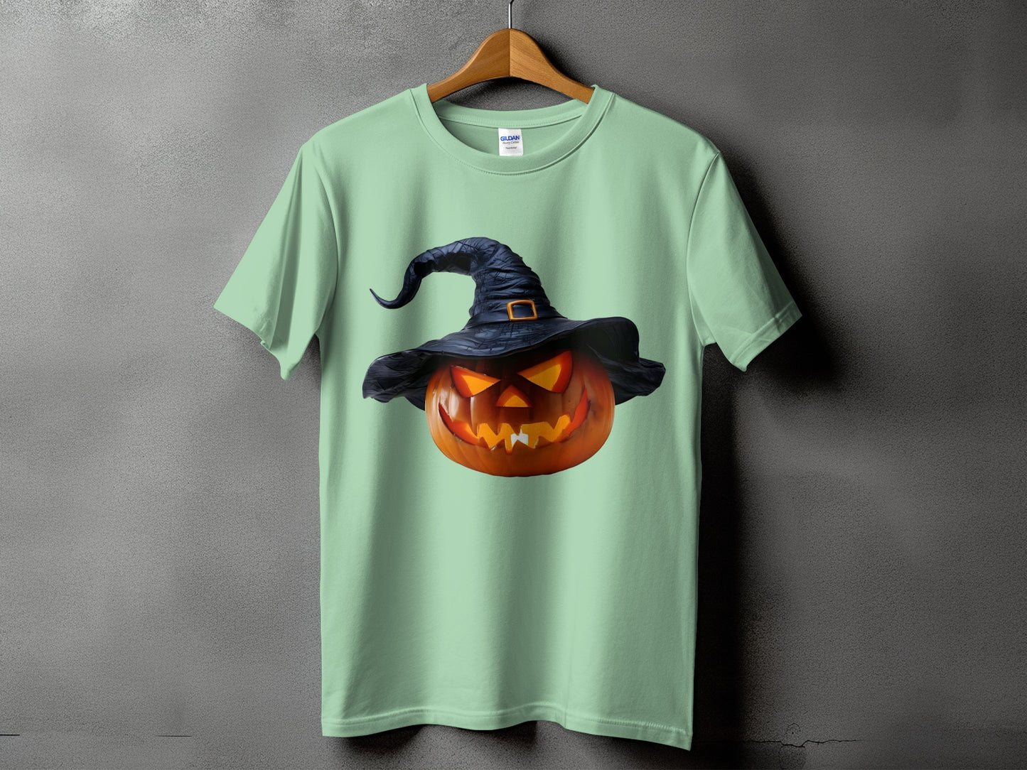 Mint green t-shirt with a jack-o'-lantern wearing a witch hat graphic.